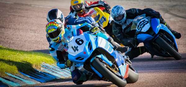 Motorcycles racing around a track.