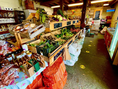 Inside of the shop showing a range of fresh fruit and vegetable as well local produce in jars and packaging.