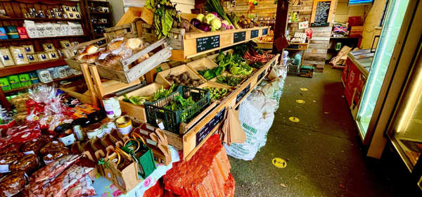 Inside of the shop showing a range of fresh fruit and vegetable as well local produce in jars and packaging.