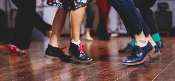 Feet dancing on a wooden floor.