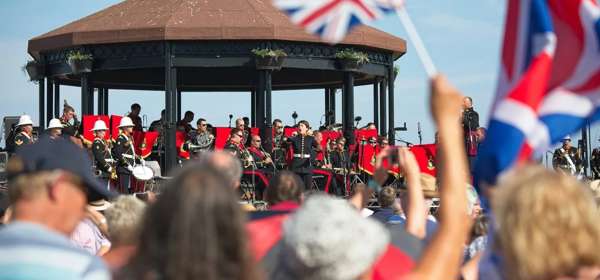 A crowd watching the band on the bandstand