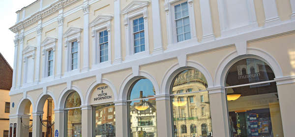 A white and cream Victorian building with arched glass frontage