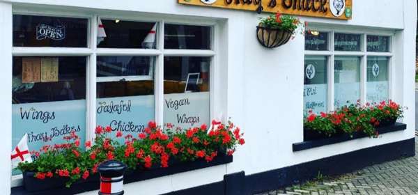 Exterior of Hay's Shack with geranium filled window boxes