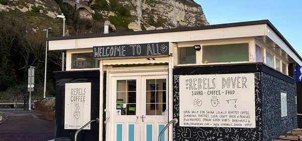 The exterior of Rebels Dover, a cafe and sauna, with the White Cliffs behind.
