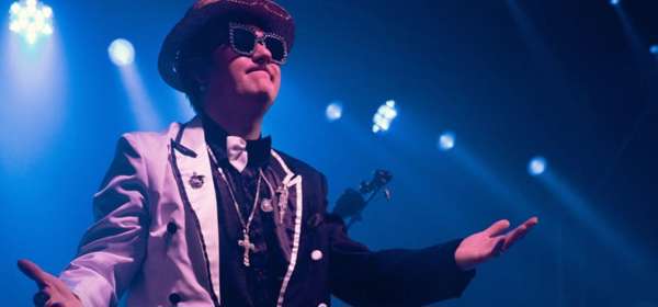 Photo of Max Anthony on stage as Elton John