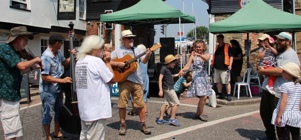 crowd of people dancing in Sandwich, Kent, town festival