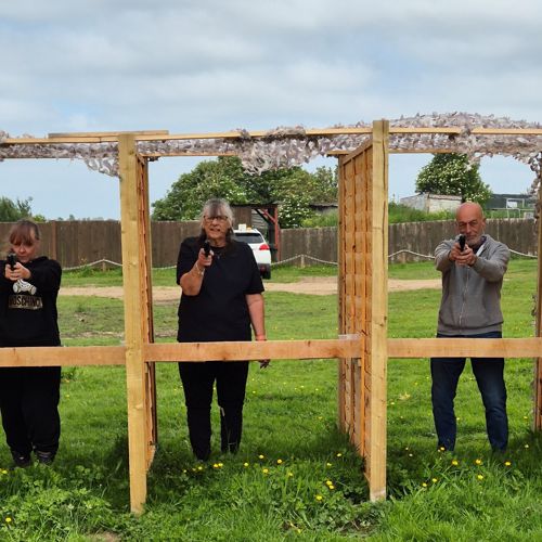 Image of 3 people aiming air pistols