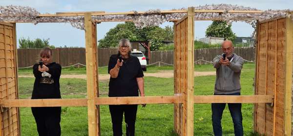 Image of 3 people aiming air pistols