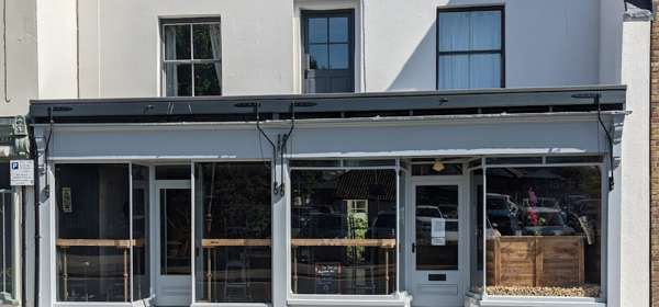 Front of The Bar with large double windows.
