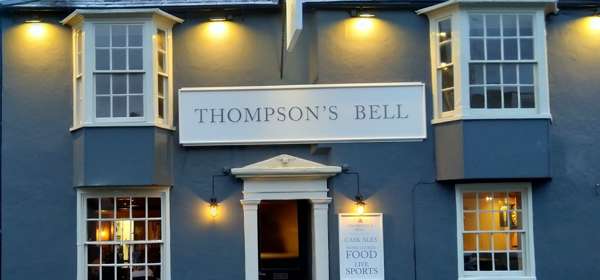 Front view of a blue painted pub called Thompsons Bell