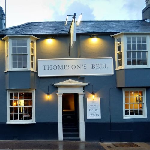 Front view of a blue painted pub called Thompsons Bell