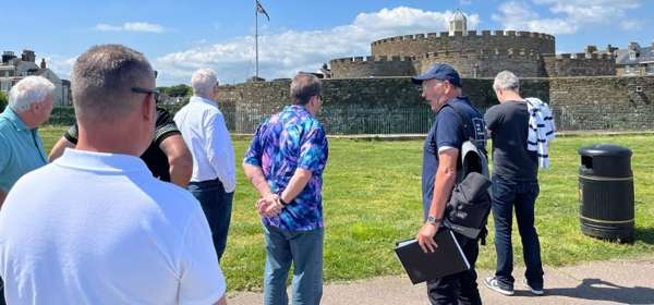 Group of men standing beside Deal Castle